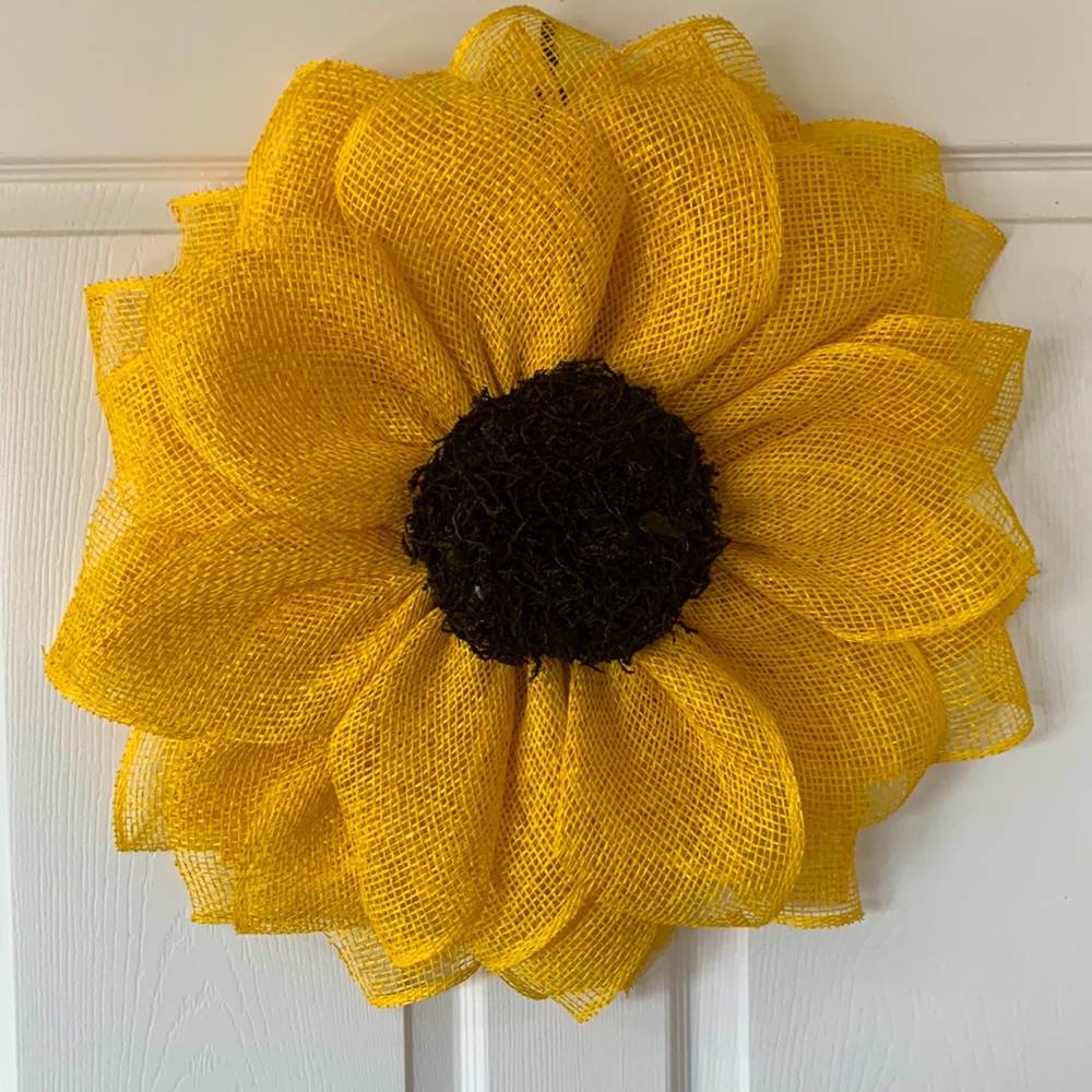 20” Sunflower wreath with poly burlap. With a center made of moss.